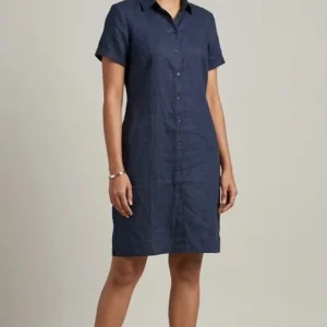 Model wearing a dark blue shirt dress with short sleeves and a round neckline, standing against a neutral background.